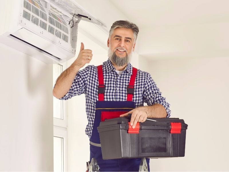 Man finished performing maintenance on air conditioning unit